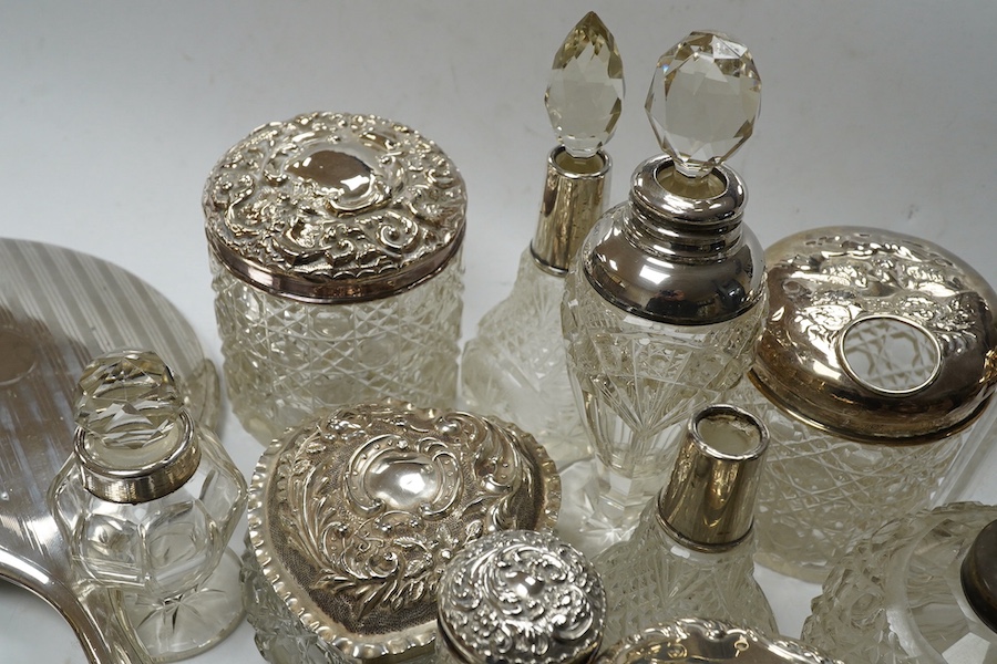 Two silver mounted hand mirrors and a collection of seventeen assorted silver mounted toilet jars. Condition - poor to fair